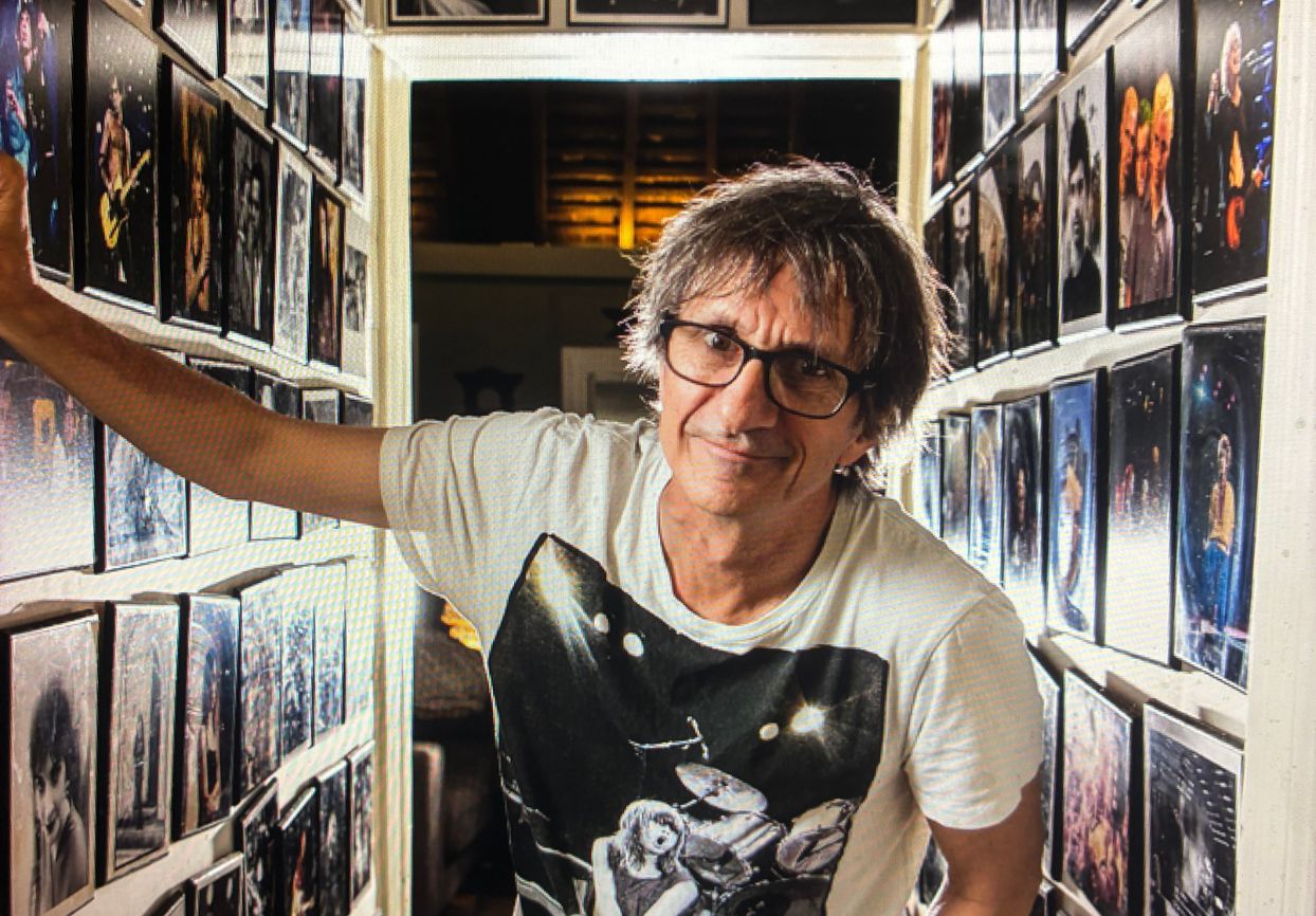 Tony Mott with a collection of his iconic music photography.