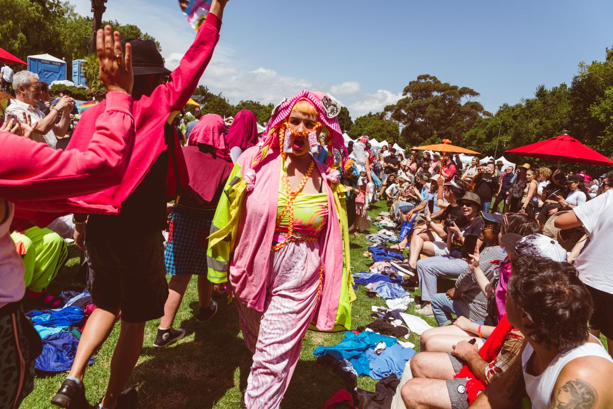 People walking the catwalk dressed in their colourful, upcycled outfits